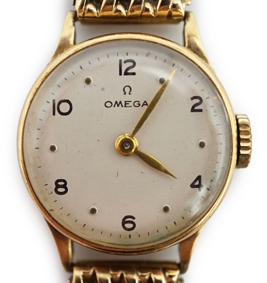 A lady's 9ct gold Omega manual wind wrist watch, on an associated 9ct bracelet, with Arabic and dot numerals, case diameter 20mm, overall length 16.7cm, gross weight 30 grams., no box or papers, with spare bracelet parts